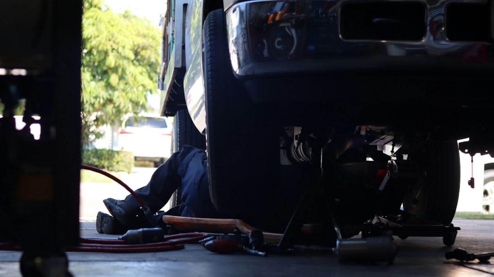 Mécanicien installant le faisceau électrique d'un attelage sur une voiture